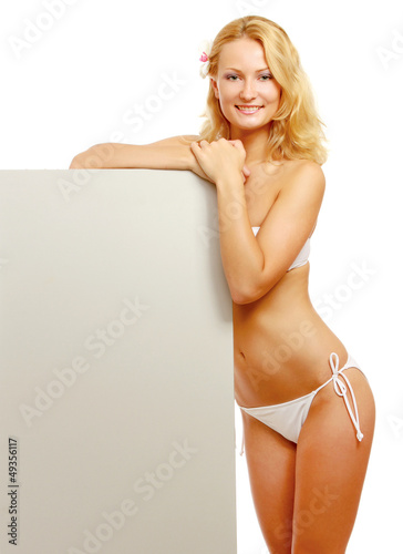 Photo: A young woman in a swimsuit with a blank A young woman in a swimsuit with a blank