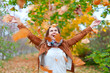 Happy woman throws  leaves
