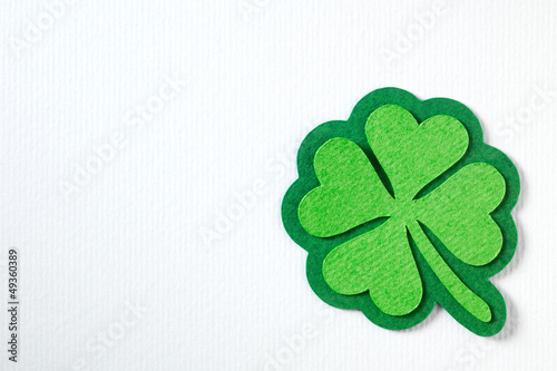 Photo: St. Patrick clover cut from paper. Greeting card. Paper craft. St. Patrick clover cut from paper. Greeting card. Paper craft.