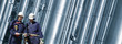 oil and gas pipelines with two workers, panoramic view