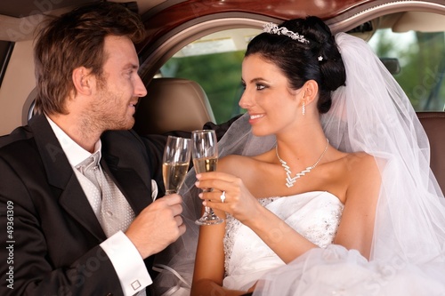 Photo: Bride and groom clinking glasses Bride and groom clinking glasses