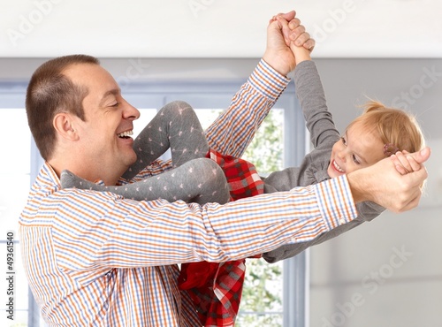 Photo: Father and little daughter playing laughing Father and little daughter playing laughing