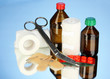 First aid kit for bandaging on blue background