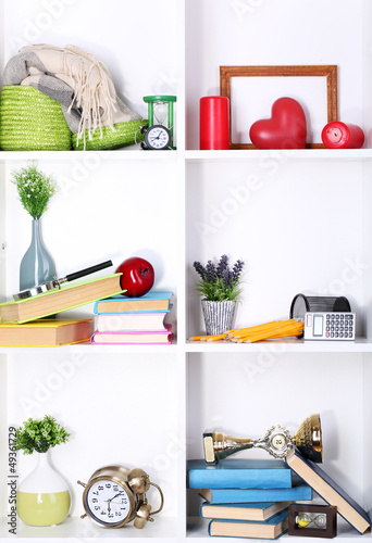 Photo: Beautiful white shelves with scattered different home related Beautiful white shelves with scattered different home related