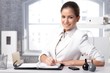 Foto: Smart businesswoman writing notes Smart businesswoman writing notes