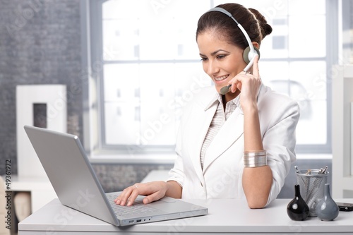 Photo: Smiling receptionist with headset Smiling receptionist with headset