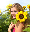 Summer: Beautiful, happy woman loves sunflowers