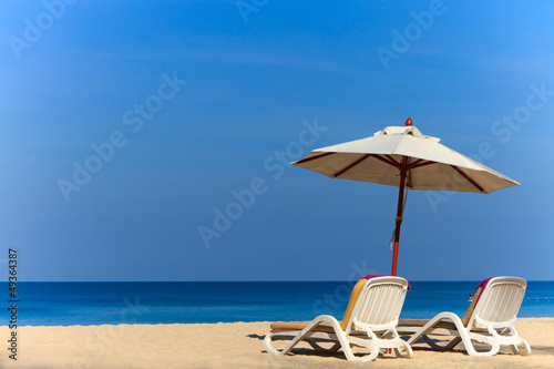 Photo: beds and umbrella on a beach beds and umbrella on a beach