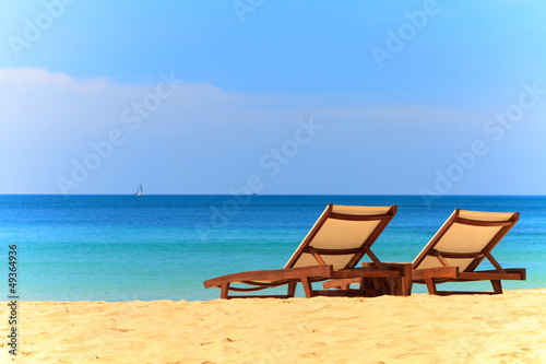 Photo: beds and umbrella on a beach beds and umbrella on a beach