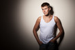 Attractive man wearing t-shirt - portrait on gray background.