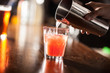 Barman serving a cocktail from a shaker