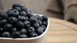 Rotating Blueberries in a bowl on a wooden plate