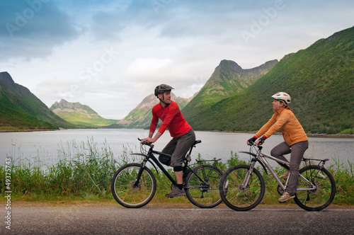 Photo: two cyclists relax biking two cyclists relax biking