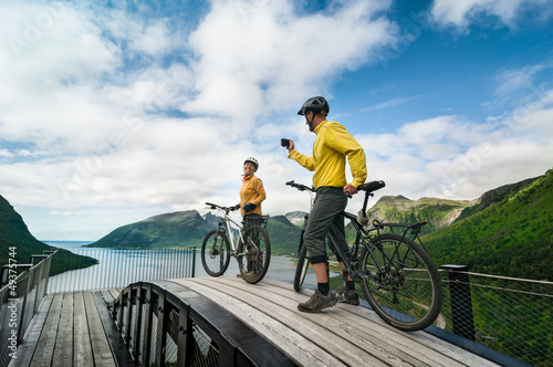 Photo: two cyclists relax biking two cyclists relax biking