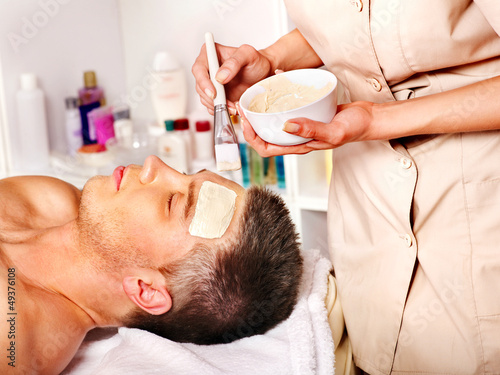 Photo: Clay facial mask in beauty spa. Clay facial mask in beauty spa.