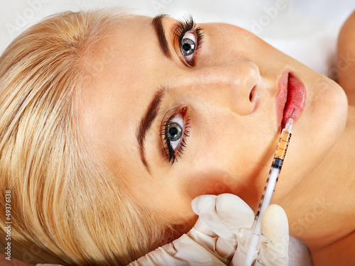 Photo: Doctor woman giving botox injections. Doctor woman giving botox injections.