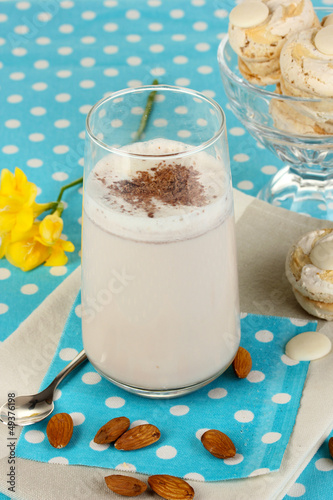 Photo: Glass of chocolate-cream cocktail on blue tablecloth close-up Glass of chocolate-cream cocktail on blue tablecloth close-up