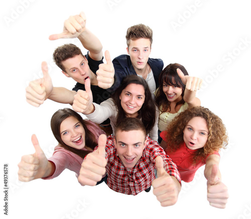 Photo: Group of happy joyful friends standing with hands up Group of happy joyful friends standing with hands up