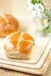 hot cross buns on wooden board, shallow dof