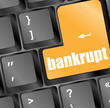 A keyboard with a yellow key reading bankrupt