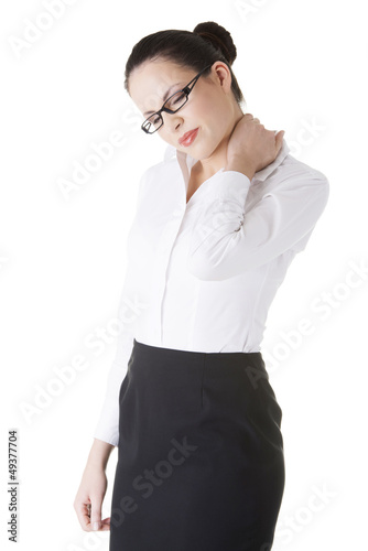 Photo: Businesswoman with back neck ache Businesswoman with back neck ache