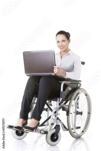 Photo: Disabled businesswoman sitting in a wheel chair Disabled businesswoman sitting in a wheel chair
