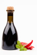 bottle of vinegar with pepperoni isolated on white