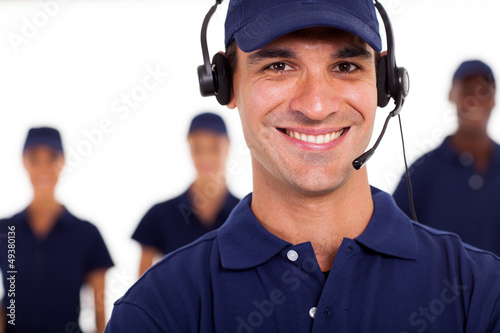 Photo: professional technician with headphones on the call professional technician with headphones on the call
