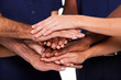 multiracial hands together to form teamwork