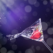 Martini drink splashing out of glass
