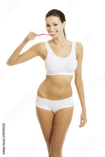 Photo: Woman with great teeth holding tooth brush Woman with great teeth holding tooth brush