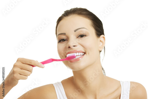 Photo: Woman with great teeth holding tooth brush Woman with great teeth holding tooth brush