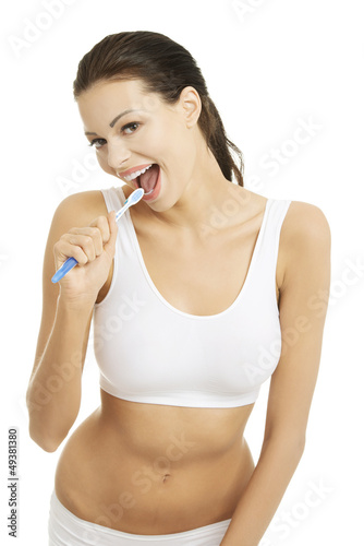 Photo: Happy pretty woman singing to tooth brush Happy pretty woman singing to tooth brush