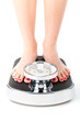Young woman standing on a scale