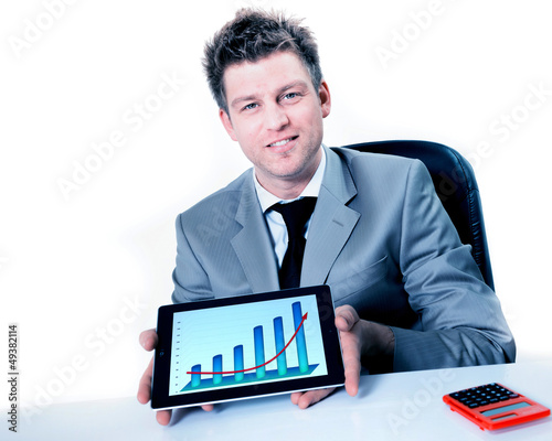 Photo: Smiling businessman holding digital tablet with positive busines Smiling businessman holding digital tablet with positive busines