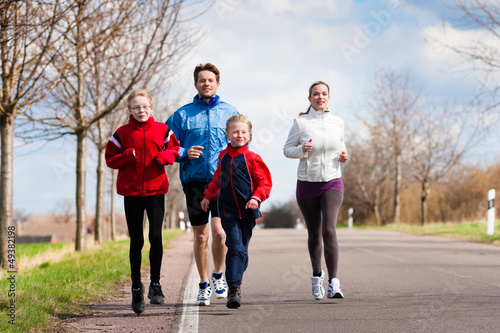 Photo: Family is running outdoors Family is running outdoors