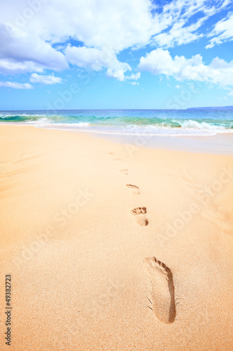 Photo: Beach travel vacation concept - footsteps in sand Beach travel vacation concept - footsteps in sand