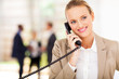 pretty businesswoman talking on landline phone in office