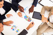 Photo: overhead view of group business people having meeting together overhead view of group business people having meeting together