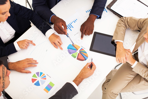 Photo: overhead view of group business people having meeting together overhead view of group business people having meeting together