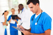 male medical worker writing report in hospital