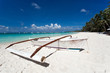 Wooden boat on tropical beach with white sand