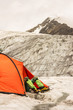 The climber has a rest lying in tent on glacier