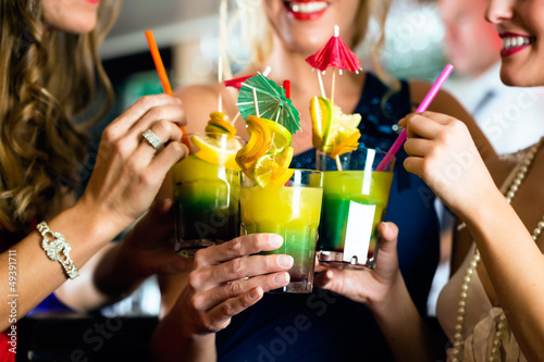 Photo: Young women with cocktails in club or Bar Young women with cocktails in club or Bar