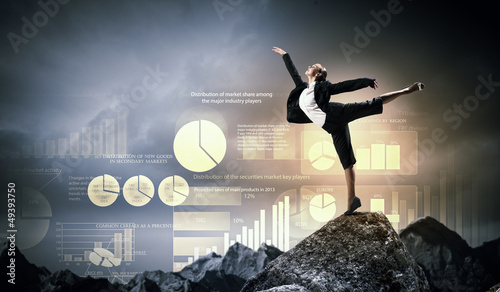 Photo: businesswoman standing atop of mountain businesswoman standing atop of mountain