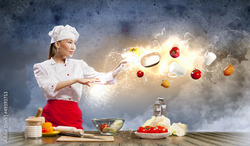 Photo: Asian female cooking with magic Asian female cooking with magic