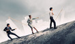 Three business people pulling rope