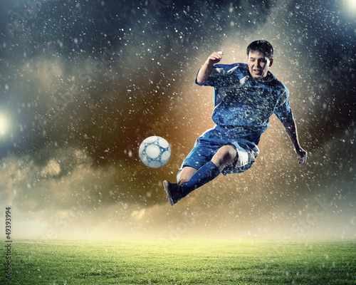 Photo: football player striking the ball football player striking the ball