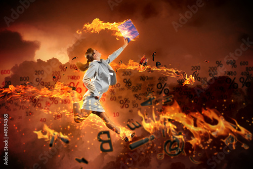 Photo: Image of running businesswoman with a fire Image of running businesswoman with a fire