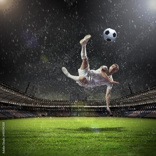 Photo: football player striking the ball football player striking the ball
